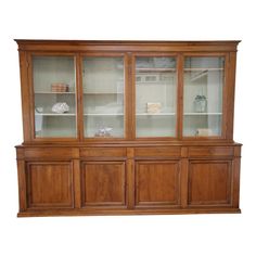 a wooden china cabinet with glass doors and shelves