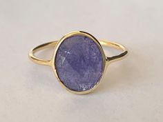 18K gold vermeil & tanzanite ring Highly polished gold ring with polished gemstone  Faceted oval tanzanite cabochon bezel set in gold vermeil Highest quality 18K gold on 925 sterling silver (92.5% pure silver) - gold vermeil & tanzanite No two pieces of natural stone are identical. Colour variations and markings in the natural stones makes this a truly unique piece Specifications:     Color: Gold & Blue    Material: 18K gold on 925 Sterling Silver & Tanzanite    Dimensions of gemstone: 10 mm x 8 mm approximately Package Includes: 1 x gold gemstone ring with complimentary jewellery pouch Gold Sapphire Gemstones, Tanzanite Round Rings As Gift, Tanzanite Round Ring As A Gift, Oval Yellow Gold Rings With Natural Stones, Handmade Tanzanite Jewelry For Anniversary, Round Sapphire Ring With Tanzanite Gemstone, Tanzanite Sapphire Ring As Gift, Elegant Oval Amethyst Ring With Natural Stones, Gold Amethyst Ring With Natural Stones As Gift