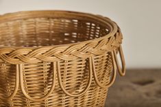 a woven basket sitting on top of a wooden table