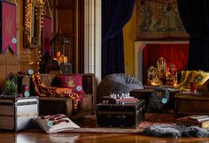 a living room filled with lots of furniture next to a fire place covered in christmas lights