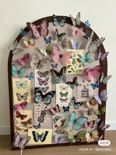 a wooden frame filled with lots of colorful butterflies