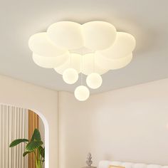 a living room filled with white furniture and lots of lights on top of the ceiling