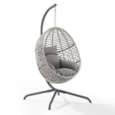 a white hanging chair with grey cushions