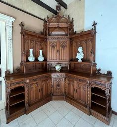 an ornate wooden cabinet in the corner of a room