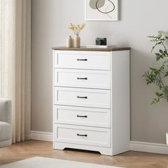 a white chest of drawers in a living room