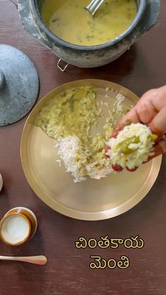 a person is eating food from a plate on a table with bowls and spoons