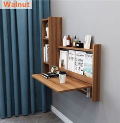 there is a desk with a book shelf on it and a cup next to it