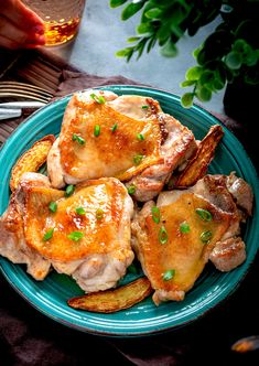 some chicken and potatoes on a blue plate