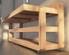 a wooden shelf sitting on top of a floor next to a wall in a room