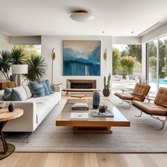 a living room filled with furniture and a painting on the wall above it's fireplace