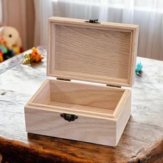 an open wooden box sitting on top of a table