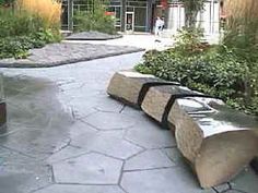 a bench sitting on top of a stone walkway