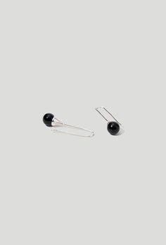 The organic shape of the piece is reminiscent of a delicate drop of water. Available in Pearl, Black Onyx or Tiger's Eye. 2 1/4" length Sterling Silver Black Onyx