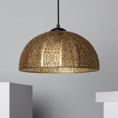 an intricately designed light fixture hangs from the ceiling in a room with grey walls