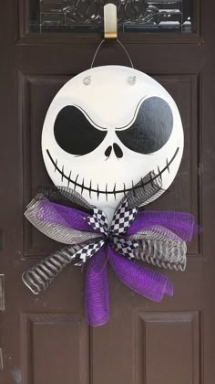 a door hanger decorated with a jack skellingy face