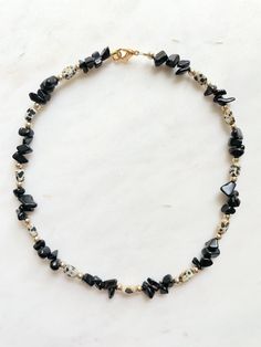 "This necklace is approximately 14.5\" with an optional 2.5\" chain extender. It features black onyx chip beads, rectangular dalmatian jasper beads and brass spacers. The closure is a 18k gold plated lobster claw. This necklace looks great on its own or layered with the other necklaces I designed for this collection. You can view the entire collection by visiting my African Turquoise shop section. If you are not satisfied with your purchase, contact me within 14 days, and return your items in th Dark Beaded Jewelry, Black Beaded Necklaces With Stones As Gift, Black Beaded Necklace With Stones, Black Beaded Stone Necklaces For Gifts, Rectangular Black Beads Jewelry As Gift, Black Beaded Necklaces With Natural Stones For Gifts, Black Handmade Beaded Necklaces For Healing, Black Gemstone Beaded Necklace With Spiritual Style, Adjustable Black Beaded Necklaces With Natural Stones