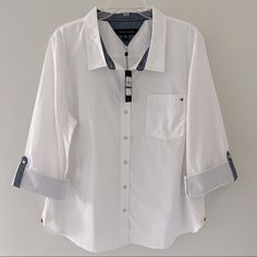 New With Tags Nwt Tommy Hilfiger White Heritage Roll-Tab Button-Up Shirt. Size 2xl. A Few Areas Of Faint Marks, As Pictured, That Can Be Removed Once Washed. No Other Flaws. Measurements: Armpit To Armpit 24” Length 28” Tommy Hilfiger Tops, Short Sleeve Tops, Cotton Shorts, Shirt Color, Workout Shirts, Short Sleeves Tops, Button Down Shirts, Button Up Shirts, Casual Button Down Shirt