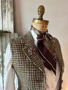 "A fitted, wool tweed vest for your winter wardrobe. This was once a houndstooth blazer and now has been altered into a vest/waistcoat. It is a 1970's Harris Tweed. I was delighted to come across this.  Wear this to dress up or down, it doesn't matter. It's one of a kind, altered by me, into a timeless piece that's a little bit more versatile than the blazer jacket it once was.  - Vintage by Civity Clothes, using a Harris Tweed. Probably 1980's or '90's. Made in England. - 100% wool tweed. - The Luxury Houndstooth Tweed Jacket For Tailoring, Luxury Tweed Jacket With Flap Pockets For Workwear, Luxury Vintage Houndstooth Tweed Jacket, Luxury Houndstooth Tweed Jacket For Fall, Luxury Tweed Outerwear With Houndstooth Pattern, Luxury Houndstooth Tweed Jacket For Spring, Luxury Brown Houndstooth Blazer, Luxury Vintage Tweed Jacket With Notch Lapel, Luxury Wool Tweed Jacket With Concealed Placket