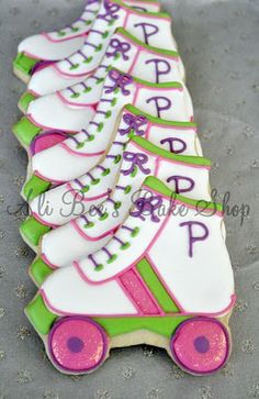 decorated cookies in the shape of roller skates with pink, green and white icing