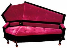 a pink and black couch sitting on top of a white floor