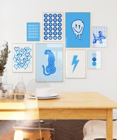 a dining room table with chairs and pictures on the wall above it, along with other items