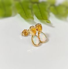 Dainty and rustic, yet elegant, these exquisite stud earrings feature a beautiful pairing of raw Citrine and Australian Opals, delicately handcrafted into a unique and one-of-a-kind design. Perfect as bridal earrings on that very special day, or to add a touch of elegance to your everyday wear - these earrings will make a unique gift for a loved one born in November.T H E ∙ S M A L L ∙ D E T A I L S• Raw Citrine (5-6mm)• Teardrop shape Australian Opals (6-8mm)• 14k Gold filled ear posts and back Born In November, Opal Stud Earrings, Raw Citrine, Opal Earrings Stud, Opal Studs, Opal Earrings, Australian Opal, In November, Bridal Earrings