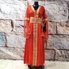 Luxurious Red And Gold Embroidered Long Bat Sleeves Abaya/Party/Gala/Lined Dress. V Neck. Comes With An Embroidered Belt. Lenght: 56 Inches Sleeves :30 Inches Chest :40 Inches Hips: 50 Elegant Red Kaftan With Zari Work, Red Floor-length Kaftan With Zari Work, Red Kaftan With Zari Work For Wedding, Red Zari Work Kaftan For Eid, Elegant Red Kaftan With Traditional Drape, Festive Red Kaftan With Dabka Work, Red Dabka Work Kaftan For Eid, Red Floor-length Dabka Kaftan, Traditional Red Kaftan With Dupatta