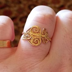 Super cute and delicated tradicional Portuguese Gold Filigree Lady Ring, Handmade with the iconic design Coração de Viana from the Minho Region. The traditional Portuguese Gold has a 800/1000 purity, 19.2 Carats Gold, wich is the most valuable gold under the 22kt from gold coins and 24kt from investment gold bars.  It is adjustable, perfect for any size finger person, and also allows you to wear the ring on any finger you want, for different looks. It has and Intricated design filled with cornuc Traditional Heart-shaped Jewelry For Weddings, Traditional Heart Jewelry For Wedding, Traditional Heart-shaped Wedding Jewelry, Adjustable Gold Filigree Ring As Gift, Adjustable Gold Filigree Ring For Gifts, Heirloom Heart-shaped Jewelry With Intricate Design, 14k Gold Filigree Ring With Intricate Design Gift, Traditional Gold Filigree Wedding Ring, Traditional Gold Filigree Ring For Wedding