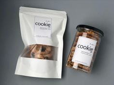 two bags of cookies sitting next to each other on a gray surface with a black and white label