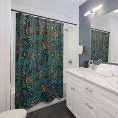 a bathroom with a shower curtain, sink and toilet