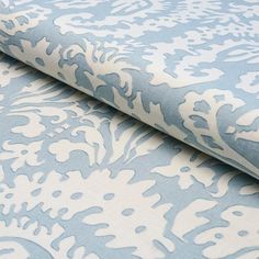 a blue and white wallpaper with an intricate design on it's surface,