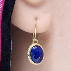 Valued by the Egyptians as a talismanlapis lazuli is still a favorite gem today. These stones are set in a14k gold setting withfiligree edge and feature french hooksfor pierced ears. Size: 3/4 inch. Gold Lapis Lazuli Gemstone Earrings, Gold Lapis Lazuli Jewelry With Cabochon, Gold Lapis Lazuli Cabochon Jewelry, Yellow Gold Lapis Lazuli Cabochon Jewelry, Gold Oval Lapis Lazuli Jewelry, Oval Gold Lapis Lazuli Jewelry, Gold Lapis Lazuli Pierced Jewelry, Gold Lapis Lazuli Jewelry, Traditional Gold Jewelry With Oval Cabochon