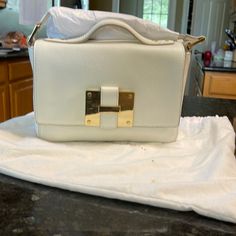 Reposhing This Item I Purchased From @Terryo22. Loved It, But Never Used It. Ready To Rotate For Something New. Questions? Leave A Comment Below! White Satchel With Gold-tone Hardware For Evening, Designer White Satchel With Gold-tone Hardware, White Satchel With Detachable Handle Shaped As A Clutch, White Satchel With Detachable Handle, Formal White Leather Box Bag, White Top Handle Box Bag With Gold-tone Hardware, Classic White Box Clutch Bag, Designer White Clutch Shoulder Bag, Designer White Leather Box Bag