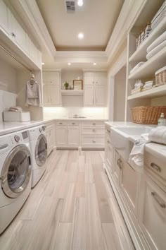 a washer and dryer in a white laundry room