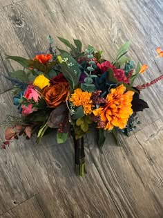 a bouquet of flowers sitting on top of a wooden floor