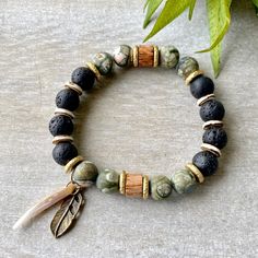 This green beaded bracelet, an authentic piece of Native American jewelry, carries positive energy and holistic healing properties. Its bohemian style makes it a meaningful gift for her or a unique accessory for men seeking connection through handcrafted artistry. 🪶 𝗠𝗔𝗧𝗘𝗥𝗜𝗔𝗟𝗦 + 𝗗𝗜𝗠𝗘𝗡𝗦𝗜𝗢𝗡𝗦 ❯  10mm Rhyolite, Jasper, Wood, Abalone, Brass ❯  Heavy Duty Elastic Cording 🪶 𝗦𝗧𝗢𝗡𝗘 + 𝗘𝗟𝗘𝗠𝗘𝗡𝗧 𝗘𝗡𝗘𝗥𝗚𝗬 ❯  NUMEROLOGY POWER OF 1 signifying courage, focus, will, and enlight Hippie Beaded Bracelets With Natural Stones For Festivals, Earthy Hand Wrapped Bracelets For Festival, Bohemian Beaded Bracelets For Meditation, Earthy Hand Wrapped Bracelet For Festivals, Hippie Healing Bracelets With Round Beads, Bohemian Stretch Bracelet With 8mm Beads For Festival, Bohemian Beaded Bracelets With Natural Stones, Earthy Round Beads Bracelets For Festival, Bohemian Stretch Bracelet With Round Beads