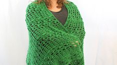 a woman wearing a green crocheted shawl