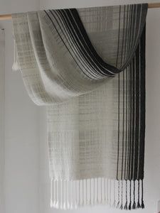 a black and white striped curtain hanging on a wall