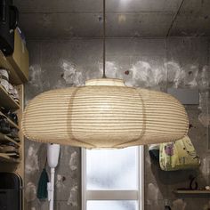 a lamp hanging over a kitchen counter next to a window