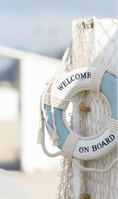 there is a welcome sign attached to the side of a boat's buoy