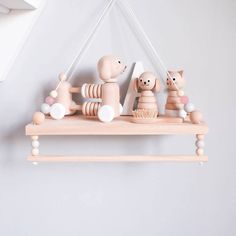 wooden toys are hanging on the wall