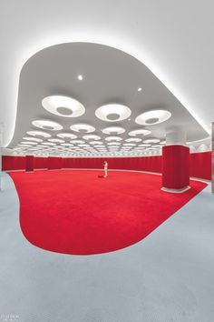 an empty room with red carpet and white walls