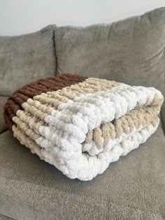 Made from high-quality, plush polyester yarn, this blanket ensures a heavenly experience, wrapping you in a cloud of comfort. Its generous size makes it perfect for snuggling up on the couch or adding a stylish accent to your bed. Whether you're curling up with a good book or enjoying a movie night, our Chunky Hand-Knitted Blanket is the epitome of warmth and relaxation. Please follow me on Instagram @chaunsamadeit And as always, thanks for supporting my small business! Brown Chunky Blanket, Blanket Puffy, Big Yarn Blanket, Chunky Blanket Diy, Hand Knitted Blanket, Crochet Queen, Chunky Blankets, Crochet Diy Tutorial, Hand Knitting Diy