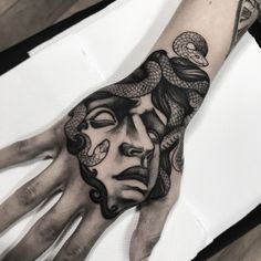 a person's hand with a tattoo on it