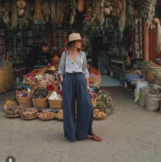 a woman standing in front of a market