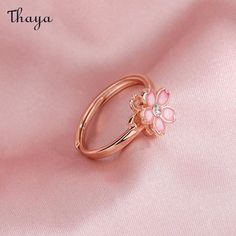 Capture the essence of cherry blossom season with our Silver Sakura Spinner Ring. This elegant piece tells a story of beauty and renewal, as delicate petals bloom and dance in the breeze. The spinner design allows for a soothing sensation, perfect for those seeking balance and serenity in their daily lives. Elevate your style with this stunning symbol of hope and new beginnings.   - Brand: Thaya  - Material: S925 Silver  - Weight : About 2.34g  - Size: Stack Mouth 14th  - Style: Flower  - Gender: Women Flower Spinner, Sweet Ring, Spinning Rings, Sakura Flower, Cherry Blossom Flowers, Fidget Rings, Twist Ring, Spinner Ring, Spinner Rings