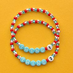 two beaded bracelets with words that say i love you, thing 1 and thing 2