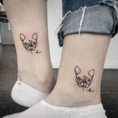 two people with matching tattoos on their feet, one has a dog and the other has a cat