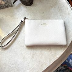 Never Used New Cream Colored Leather Wristlet By Coach. Chic On-the-go Wristlet Clutch, Chic Everyday Coach Clutch, White Bag With Wrist Strap As Gift, White Clutch For Daily Use, White Coach Clutch With Zipper Pouch, Everyday White Bag With Wrist Strap, Elegant Coach Pouch For Everyday, Chic White Wristlet For Everyday Use, Classic Wristlet With Zipper