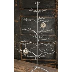 a metal christmas tree with ornaments on it